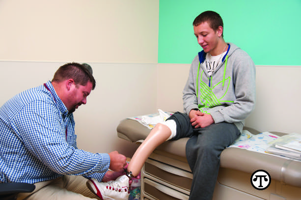 Darren Rottmann fitting a patient for a new prosthetic.