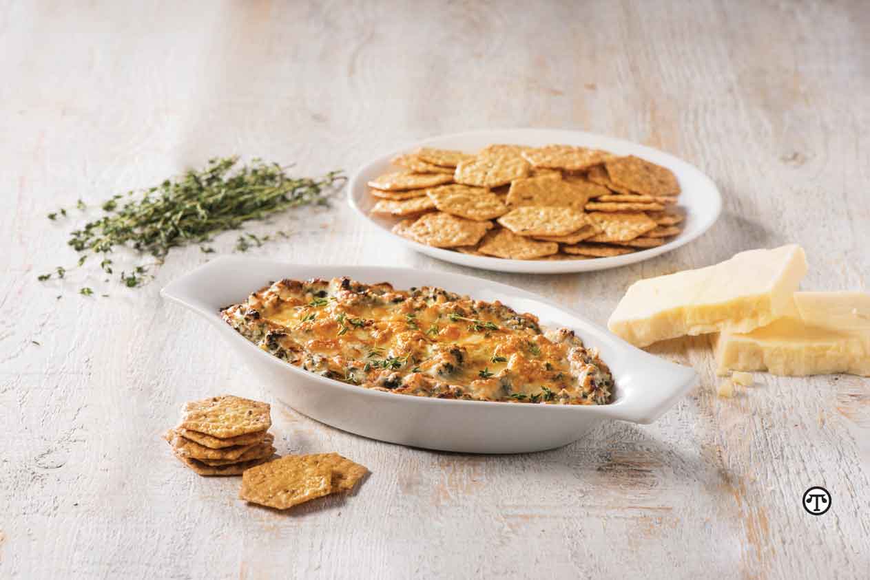 Serve this warm spinach and artichoke dip with crisp Crunchmaster® crackers for a partygoer’s palate-pleaser.