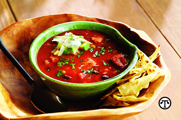 Hearty chicken tortilla soup made with R.W. Knudsen Family Organic Tomato Sriracha juice is a flavorful way to warm up and keep veggies in your diet all winter long.