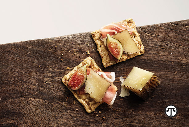 For a sophisticated gluten-free hors d’oeuvre, top organic Harvest Stone® Crackers with Manchego cheese, prosciutto and fig slices.
