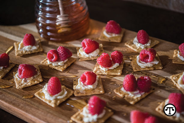 Harvest Stone® organic crackers are delicious topped with cream cheese, raspberries, and drizzled honey.
