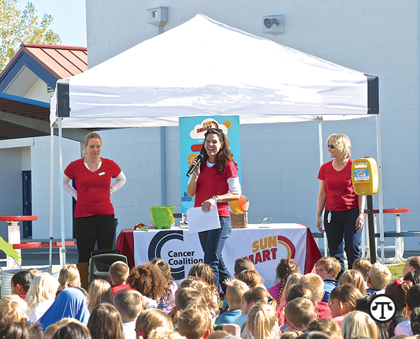  Image credit: Brad Coman, Gardnerville Record-Courier Nevada Cancer Coalition staff, Cari Herington (center) and Christine Thompson (right), and intern Bria Hosier (left) lead a Sun Smart Schools kickoff assembly at Gardnerville Elementary School in Douglas County. 