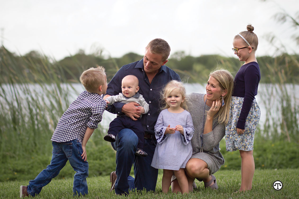 John and Jennie with their family in the backyard of their new Delray Beach, Florida home. John is a loan officer who followed his own advice when he purchased their new home with a conventional loan and private mortgage insurance. The low down payment allowed him to keep some cash in reserve.